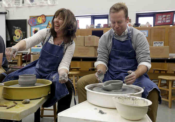 Kelly Helser, art teacher, can't help but laugh as Todd Sautters, social studies teacher, both with Canal Winchester High School, reacts to his bowl losing its shape on a pottery wheel at Canal Winchester High School. CWHS faculty and students are creating ceramic bowls for the Canal Winchester Human Services' SOUPer Bowl fundraiser. Guests who attend the event can enjoy a free lunch of homemade soups and desserts and purchase the ceramic bowls for $10. All proceeds go toward helping the day-to-day operations at Canal Winchester Human Services.  (Shane Flanigan / ThisWeek Community News)